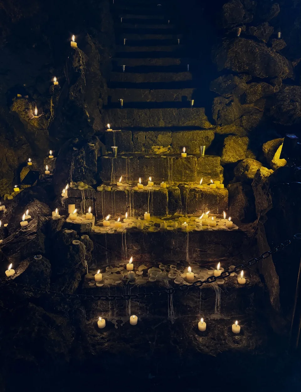 The stone stairway of the grotto lined with candles at La Gruta Teotihuacan