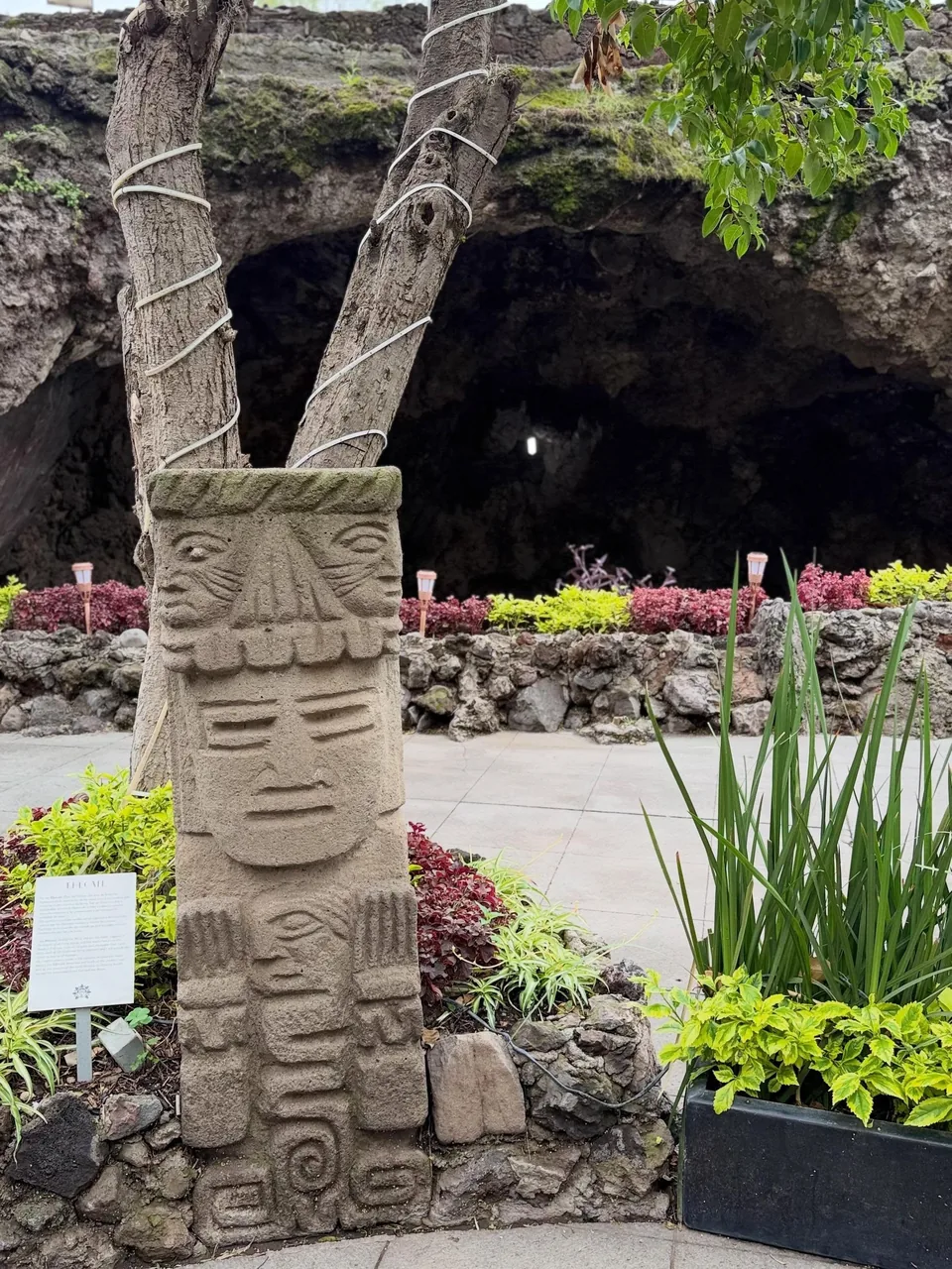 A carved stone sculpture at the entrance to La Gruta Teotihuacan